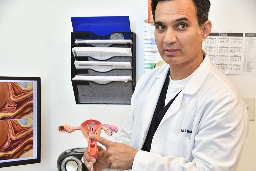 Dr. Malik explaining anatomy with a uterus model